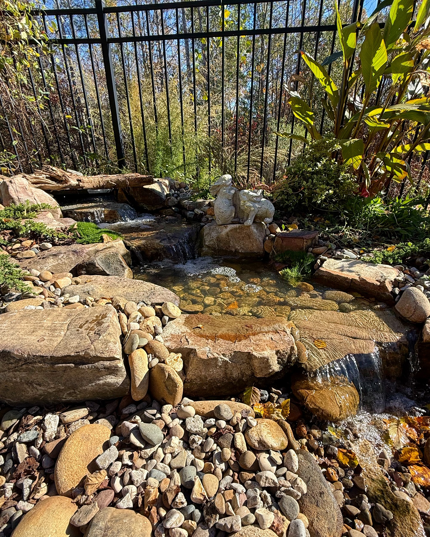 Garden waterfall with rocks and plants